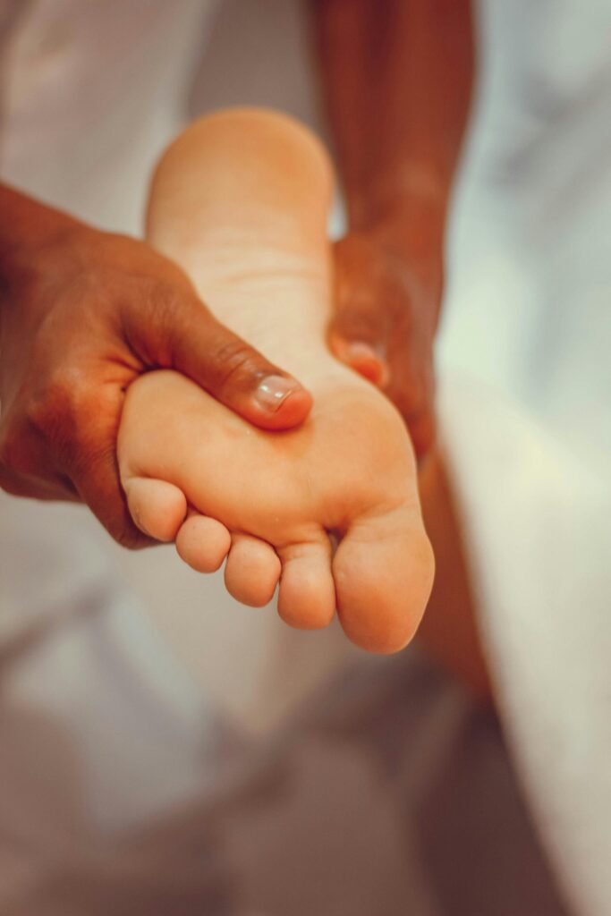Close-up of therapeutic foot massage for relaxation and pampering in a spa setting.
